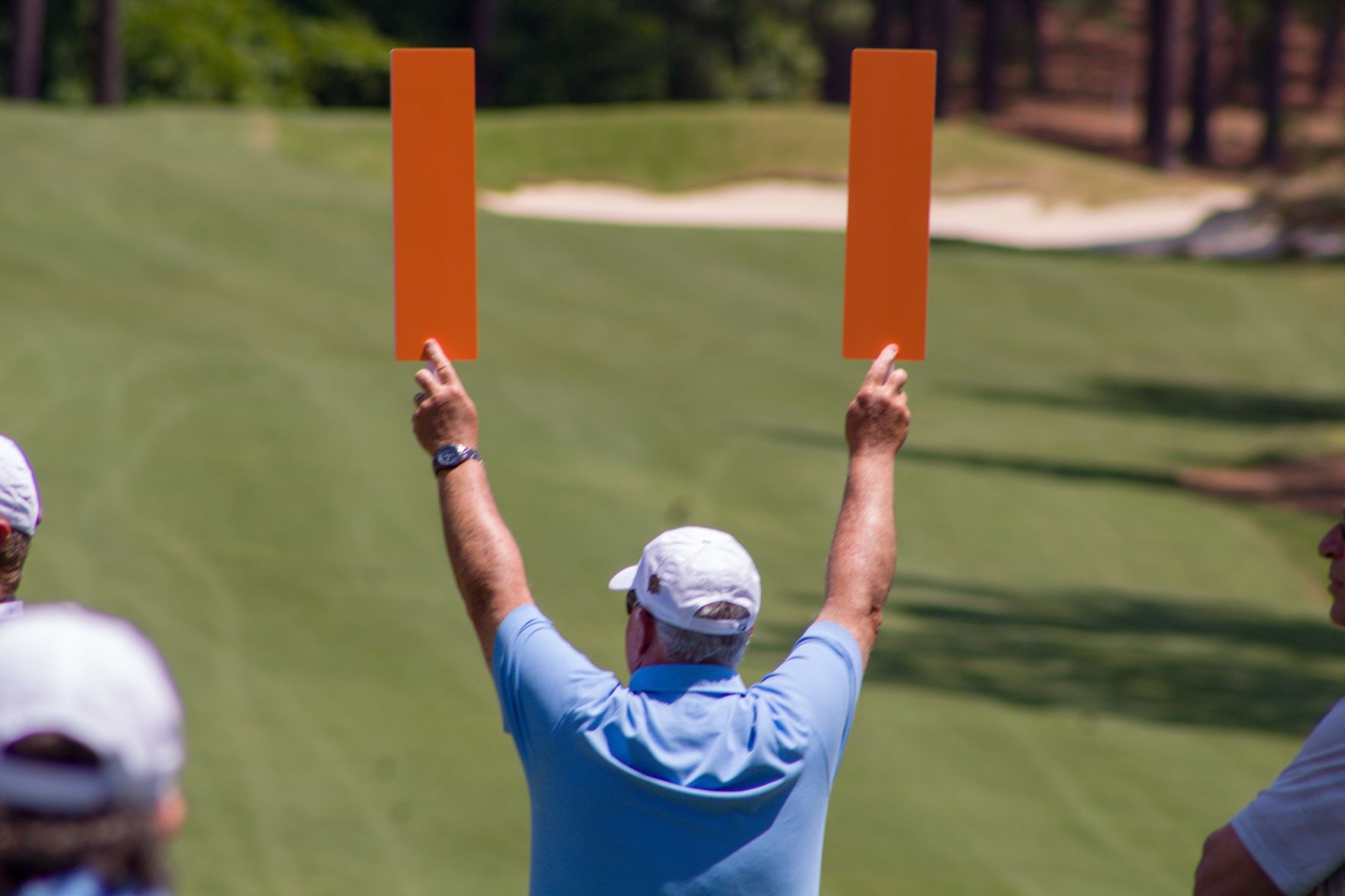 A marshal signals during the 2019 U.S. Senior Women's Open at Pine Needles.